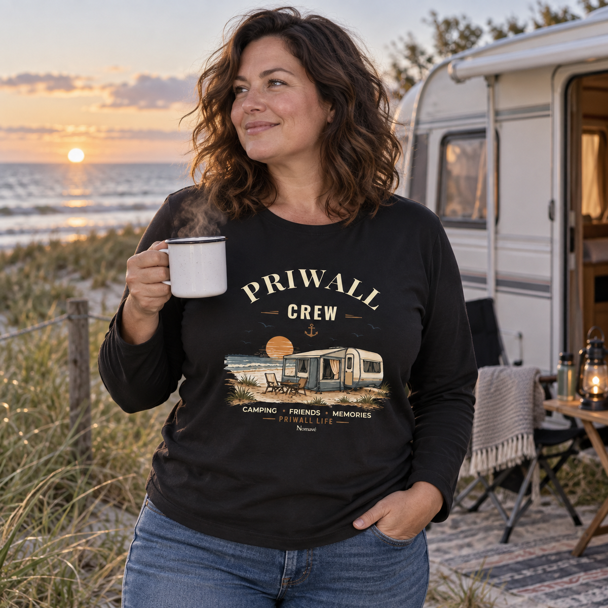 Frau im schwarzen Bio Longsleeve mit Priwall-Crew-Motiv auf einem Campingplatz an der Küste