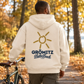 Grömitz Sonne Bio Oversize Hoodie Natural Raw mit Rückendruck – Mann mit Fahrrad im Herbstpark, KI-Produktvisualisierung