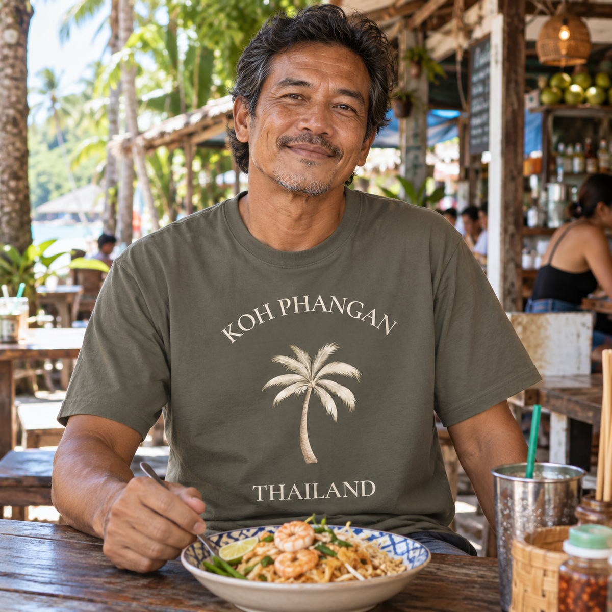 Bio Heavy T-Shirt in Khaki mit Koh Phangan Mini Palm Frontprint in einem thailändischen Café