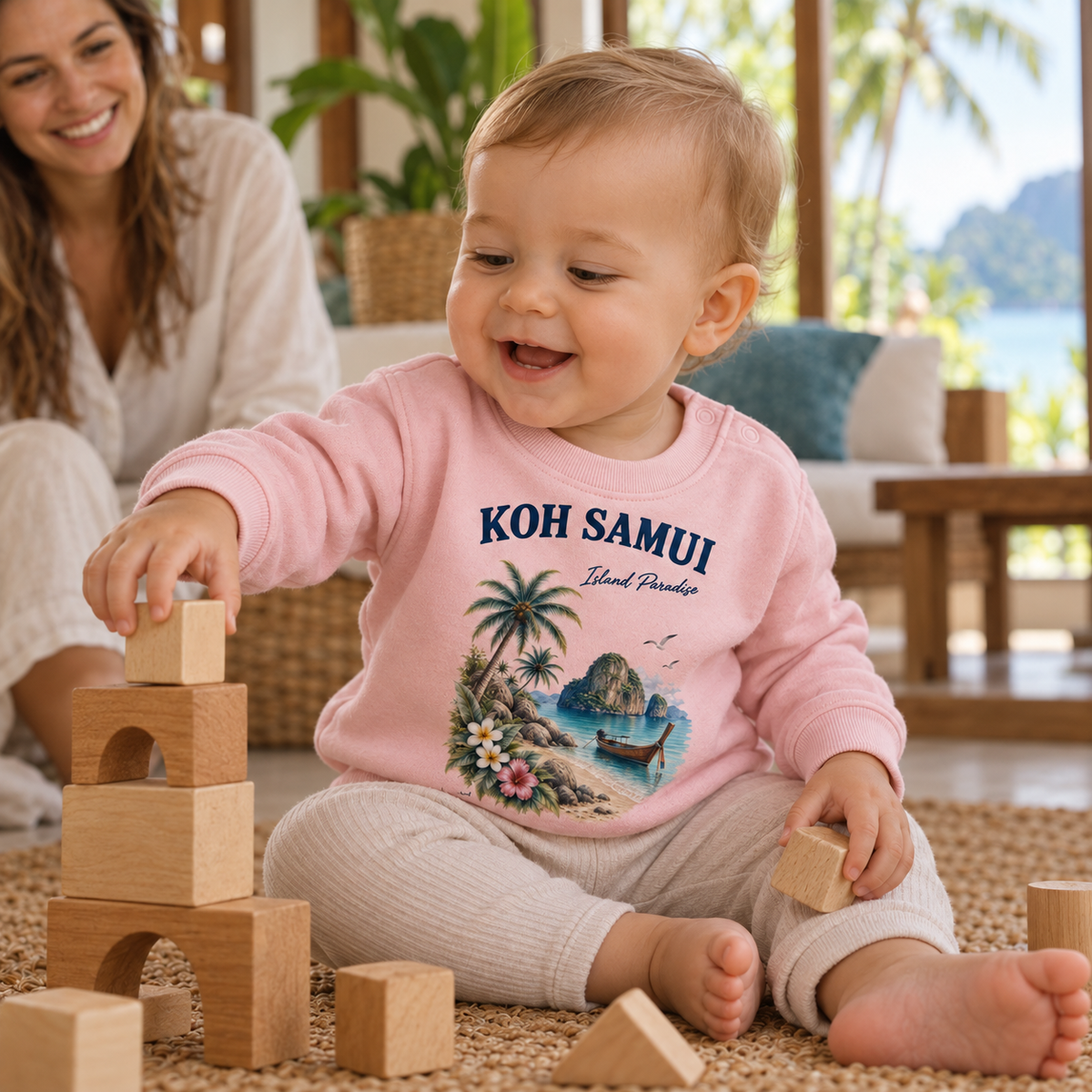 Kleinkind im Cotton Pink Koh Samui Island Paradise Baby Sweatshirt beim Spielen mit Holzbausteinen
