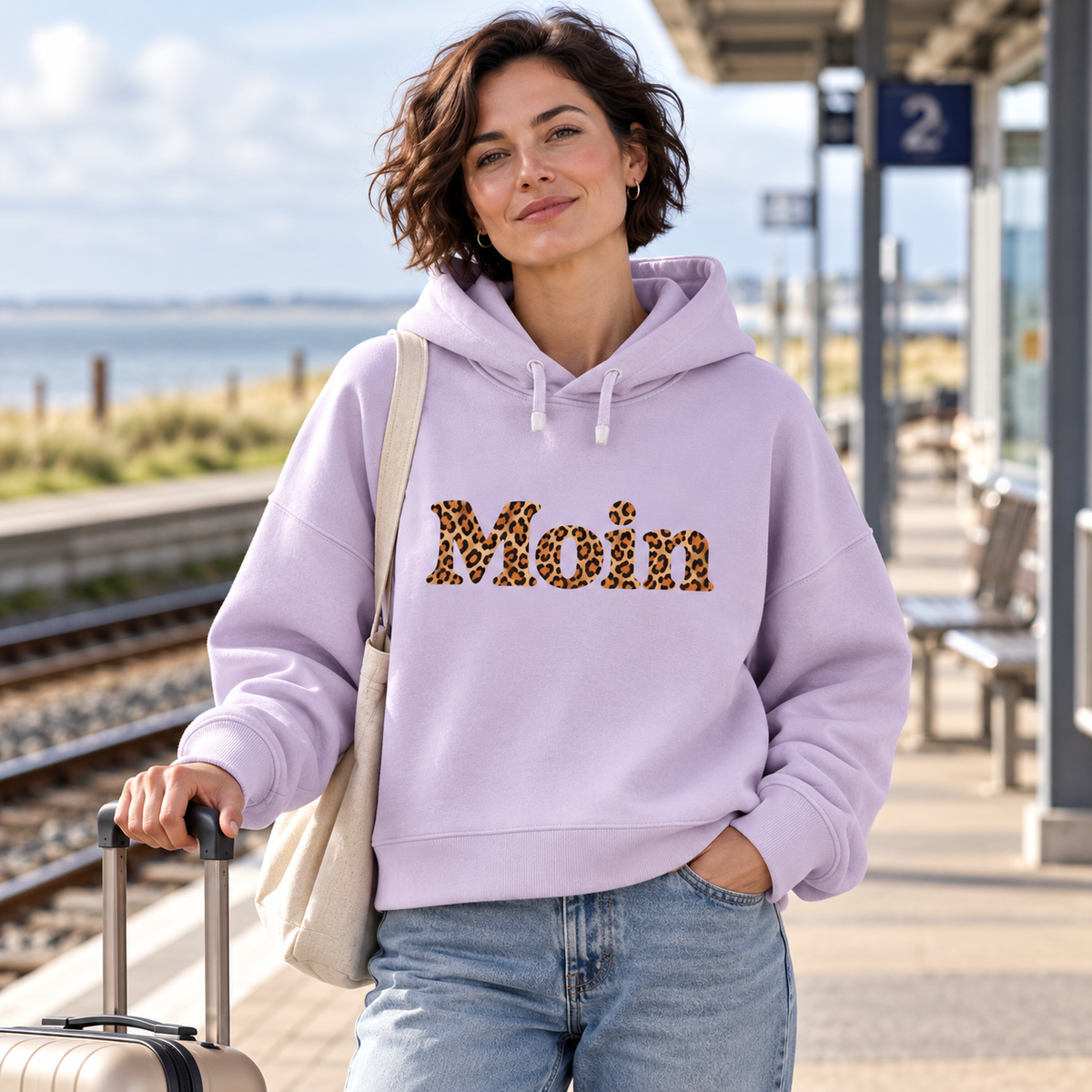 Damen Bio Boxcut Hoodie in Lavender mit Moin-Leoprint am Küstenbahnhof