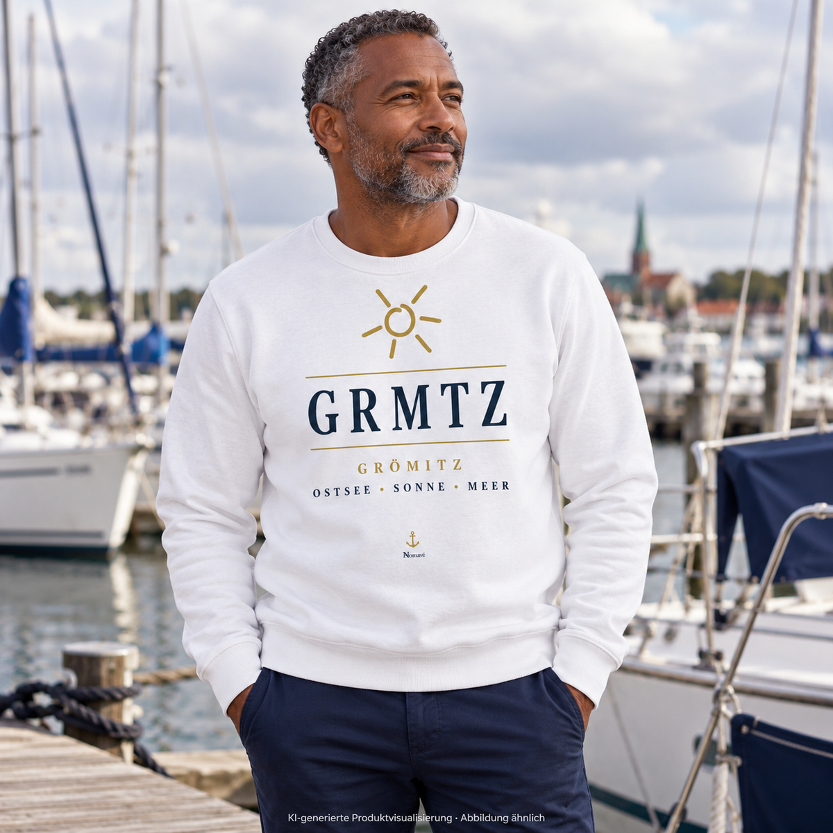 Mann im weißen GRMTZ Grömitz Bio-Sweatshirt am Segelhafen – Frontmotiv mit Sonne und Anker; KI-Visualisierung.