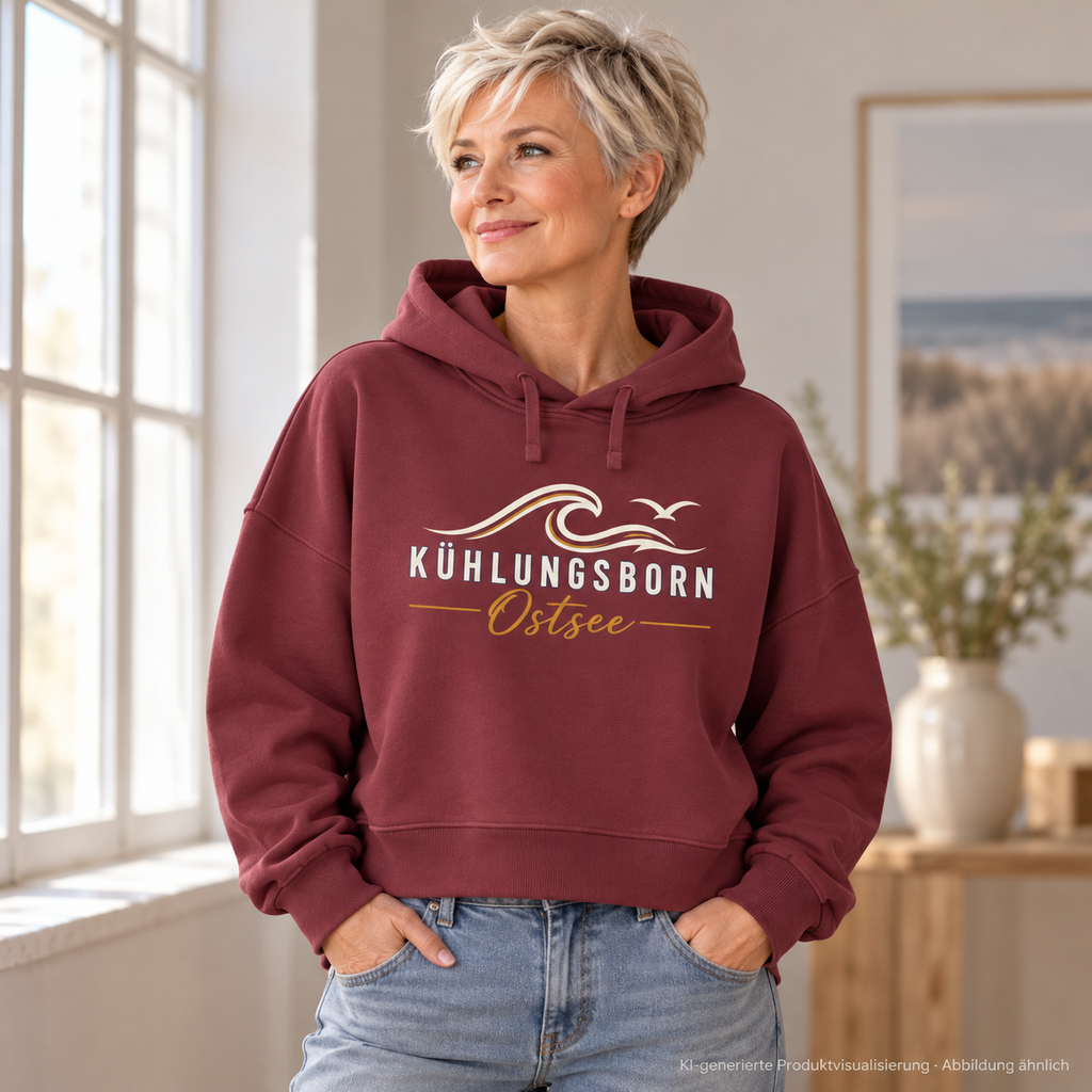 Damen Bio-Boxcut-Hoodie Kühlungsborn Baltic Waves, Dark Edition, Burgundy – am Atelierfenster, Frontdruck; KI-generierte Produktvisualisierung.