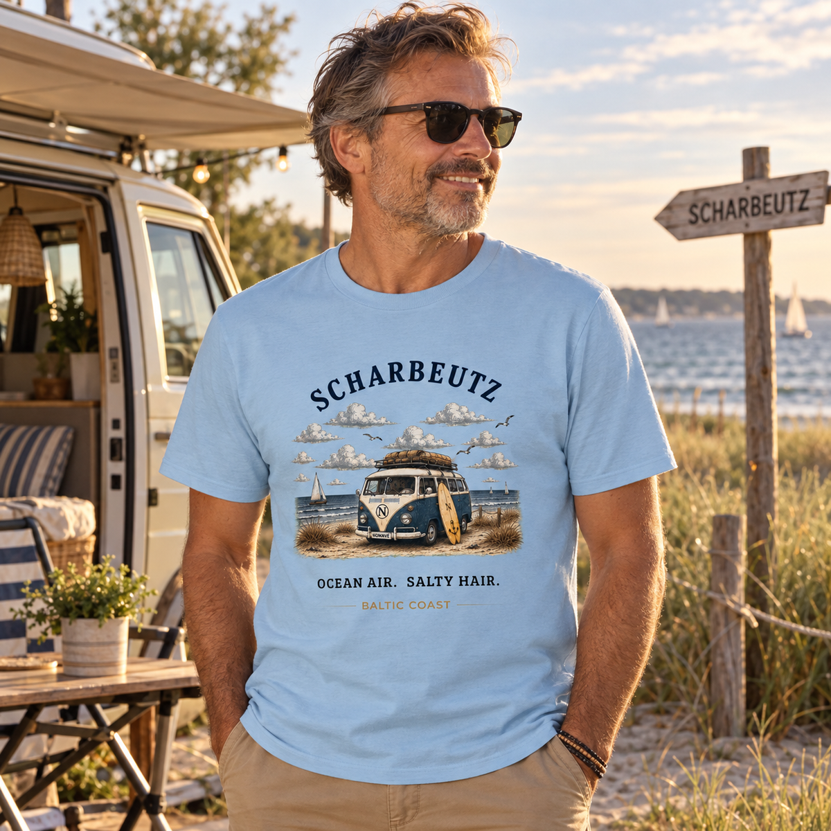 Mann trägt das Light Blue Scharbeutz Bulli Essential T-Shirt beim Camping an der Ostsee